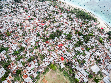 fishing village on african island with rows of poor houses, top view, aerial photoの写真素材