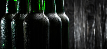Green bottles with beer on black backgroundの写真素材