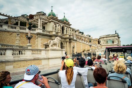 Budapest, Hungary - July 07, 2015: tourists on bus taking pictures near lower part of Buda castleのeditorial素材