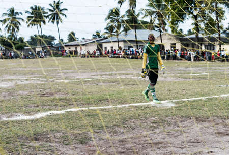 Zanzibar, Tanzania - July, 14, 2016: young african goalkeeper on football field in uniform near gate in Zanzibarのeditorial素材