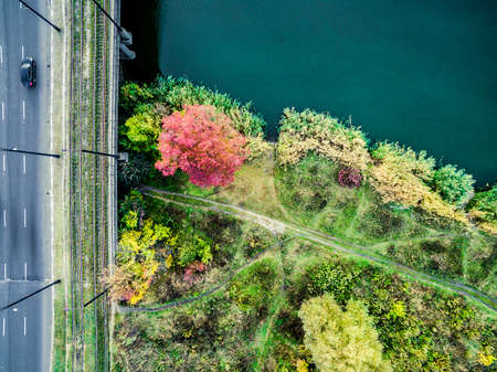 Aerial view - city bridge above the river and autumn meadowの写真素材