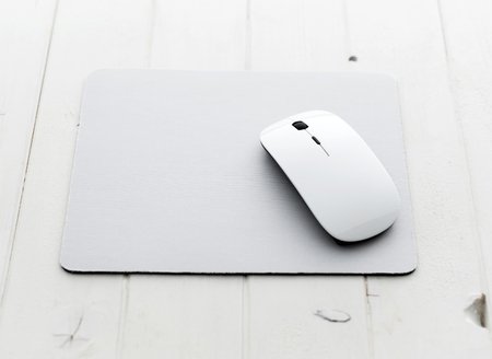 White wireless mouse on a mouse padの写真素材