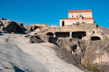 caves and house on the hill in Uplistsikhe, Georgiaの写真素材