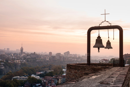 bells and beautiful view of Tbilisi from Narikala fortress, Georgiaの写真素材
