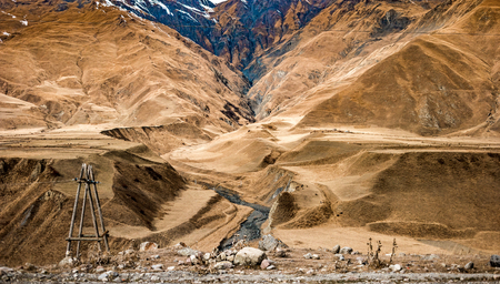 beautiful mountains with poles with wires in Georgiaの写真素材
