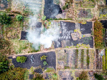 suburb terrain with markings dividing it on pieces with smoke, top view, aerial photoの写真素材