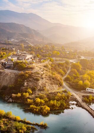 Georgia, view on the ancient mountains, a river flowing nearby, old building, aerial shotの写真素材