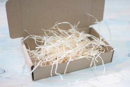 gift cardboard box with wooden shavingsの写真素材
