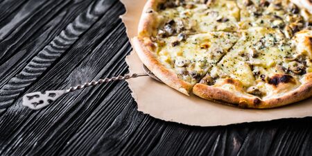 Delicious italian pizza on wooden backgroundの写真素材