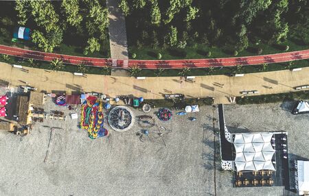 Aerial view of amusement park at the shoreline, bicycle path and green park