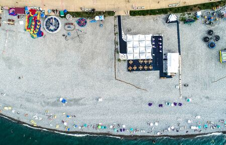 Aerial view of beach with terrace, some rides and people taken sunbath. Top view. Batumi, Georgiaの写真素材