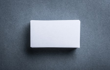 Stack of blank white business card on grey background. Blank name card.の写真素材