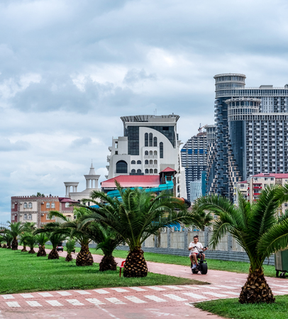 Batumi, Georgia - 27 August 2017: Embankment in Batumi with green palms and scyscrapers on the background, Georgiaのeditorial素材