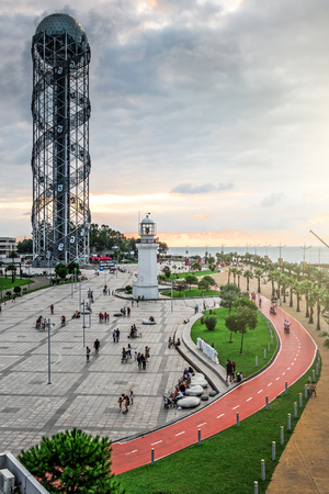 Batumi, Georgia - 27 August 2017: Top view of old Pitsunda Lighthouse in Miracle Park. People walking along embankment.のeditorial素材