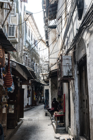 Zanzibar, Tanzania - July 15, 2016: Narrow empty street on zanzibar, buildings really close to each other, small local shopsのeditorial素材