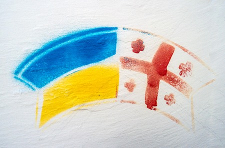 Kutaisi, Georgia - 05 November 2016: drawn Ukrainian and Georgian flags together on white wall in Kutaisi, Georgia, symbol of friendshipのeditorial素材