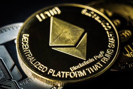 Golden ethereum coin laying on dark background. Digital currency, cryptocurrency concept