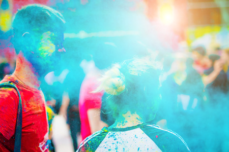 Crowd of people dancing and celebrating Holi festival of colors.の写真素材