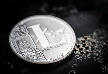 Litecoin laying on computer motherboard. Virtual currency. Crypto currency. New virtual money