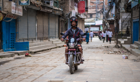 Kathmandu, Nepal - 06 October 2017: Man driving motorbike on the desolate street of Kathmandu, Nepalのeditorial素材