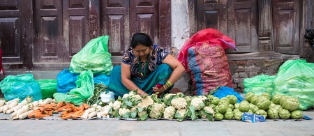 Kathmandu, Nepal - 06 October 2017: Women in traditional clothes sold fresh organic vegetables on the street market, Kathmanduのeditorial素材