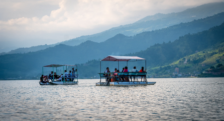 Pokhara, Nepal - 14 November 2017: Tourists have an excursion on boats on Phewa lakeのeditorial素材