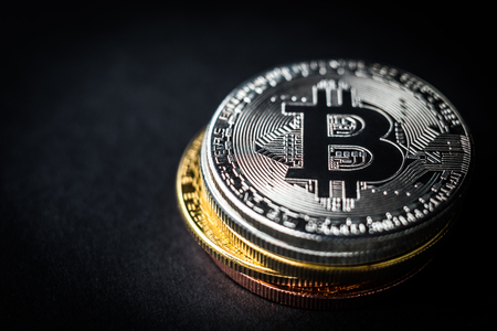 Pile of bitcoin coins on dark background. Silver bitcoin on the grey background. Digital cryptocurrencyの写真素材