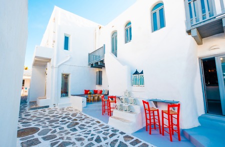 bright red chairs and sitting place inside of big buildings courtyard on the greek streetの写真素材