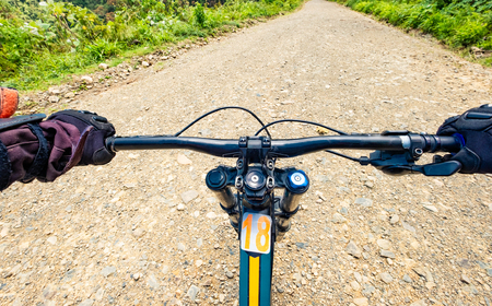 Top view of bike steering wheel while riding on the slopeの写真素材