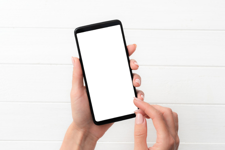Template of using black smartphone on white table background for your designの写真素材