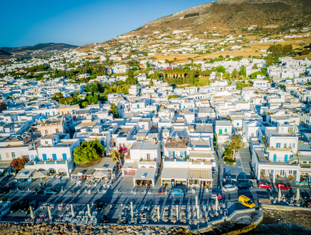 Cozy resort town by the seaside, Paros, Greece. Birds eye view of traditional white houses at sunsetの写真素材