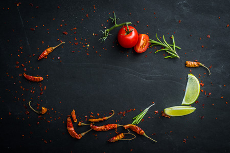 Dark textured table with vegetables on itの写真素材
