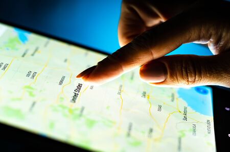 Kharkiv, Ukraine - 12 November 2018: close up girl hand using tablet with Google map app on the...