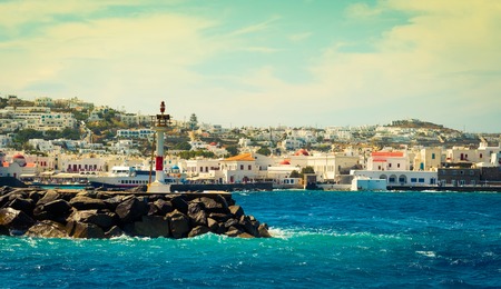 Beautiful view to Mykonos city and lighthouse from seasideの写真素材