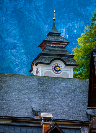View of church little tower clock of high mountains, in Hallstatt,Austria