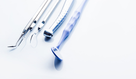 Closeup of dental instrumets on white tableの写真素材