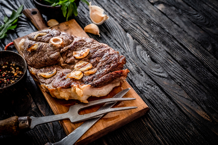 Grilled lamb meat with garlic on a wooden boardの写真素材