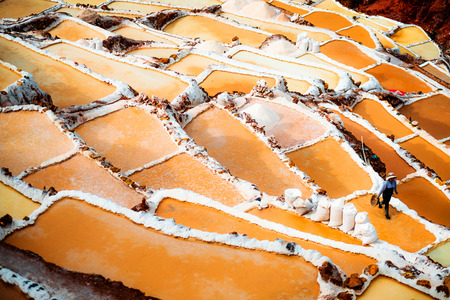 Worker at Salinas de Maras near Cusco, salt extraction in Peruの写真素材