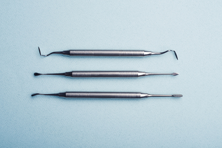 Metal dental tools on light blueの写真素材