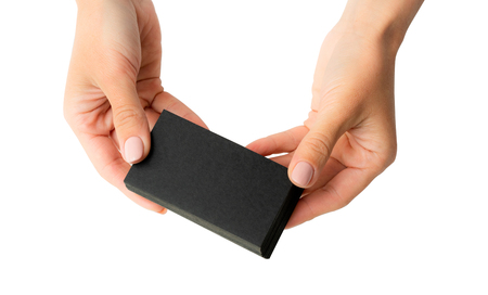 Woman holding stack black business cards in hands isolated on a whiteの写真素材