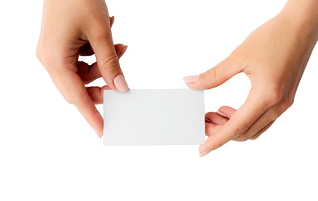 Woman holding white business card in hands isolated on a whiteの写真素材