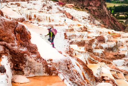 Cusco, Peru - 12 october 2018: Worker at Salinas de Maras near Cusco, salt extraction in Peruのeditorial素材