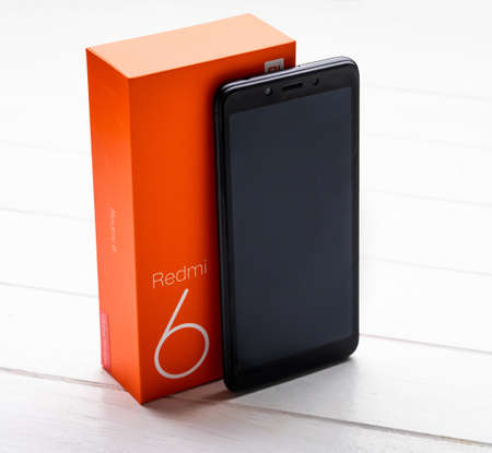 Kharkiv, Ukraine - 02 Fabruary 2019: New Xiaomi Redmi 6 smartpphone on a wooden table