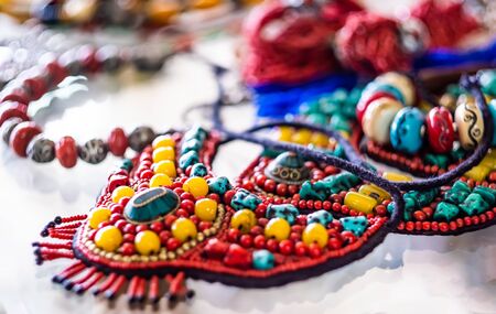 Beaded necklace from colorful beads on transparent tableの写真素材