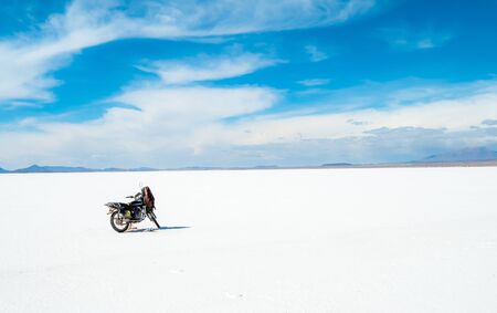 Motorbike on the background of spacious sunshine Salar de Uyuni