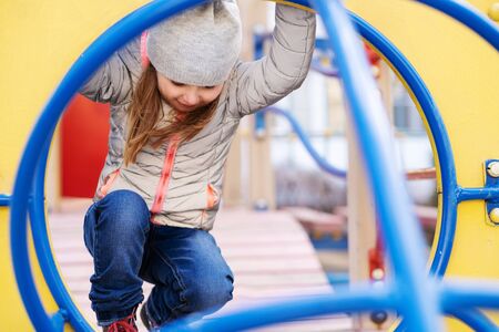 Happy girl playing at the playgroundの写真素材