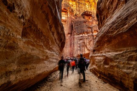 Group of people between sandstone rocks at narrow path in Petra, Jordanの写真素材