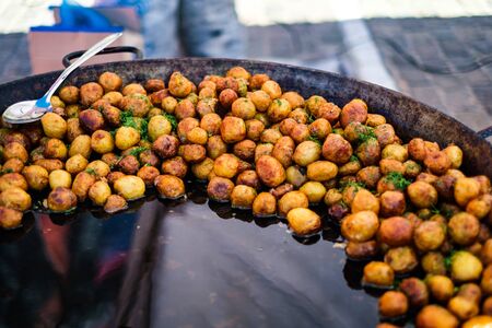 Fried potatoes in big pan, street foodの写真素材
