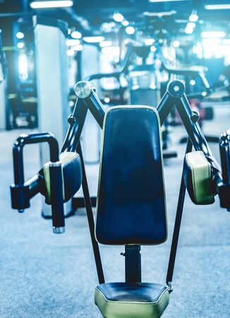 Fitness and bodybuilder machine for shoulders in gym hallの写真素材