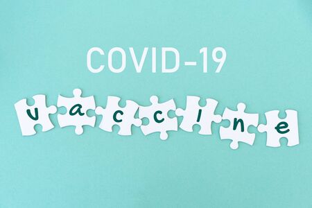Jigsaw puzzle pieces with coronavirus vaccine, blueの写真素材